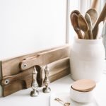 brown wooden spoons on ceramic canister on white top surface