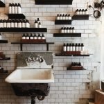 bottles on wall shelves above sink