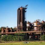 a large factory with a large tower with Gas Works Park in the background