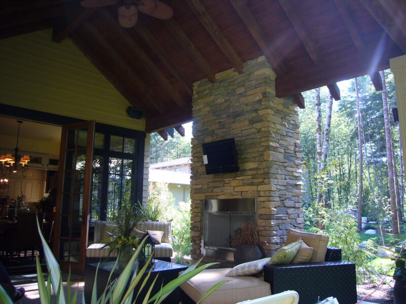 outside patio with tv above fireplace