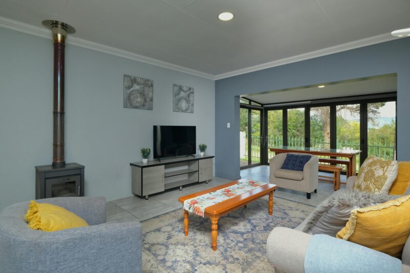 Spacious modern living room with cozy decor and dining area view in a home.