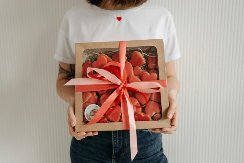 Box of heart-shaped cookies with ribbon for Crumbl birthday