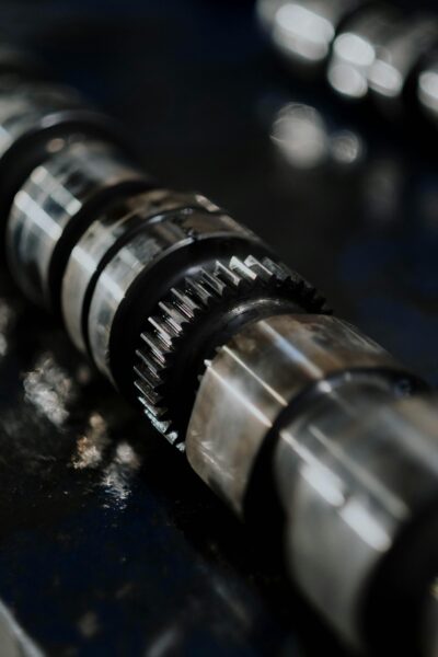 Detailed image of camshaft highlighting gears and reflections, automotive technology