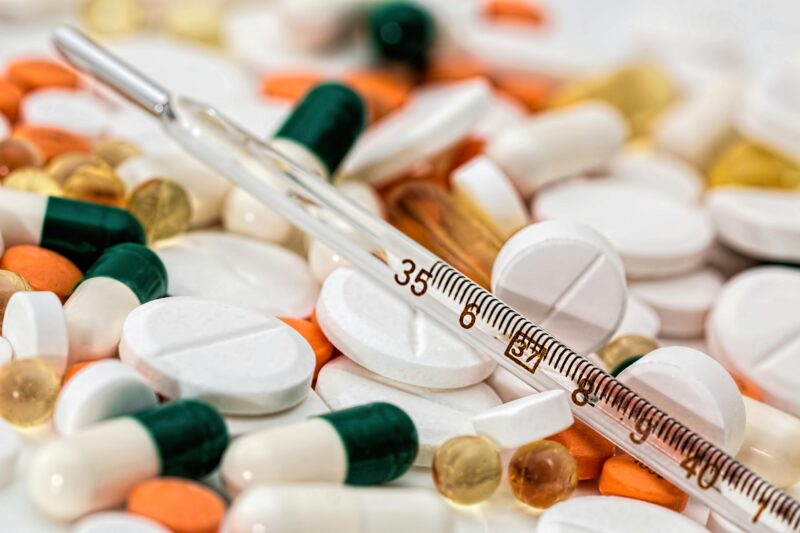 Various health pills and thermometer