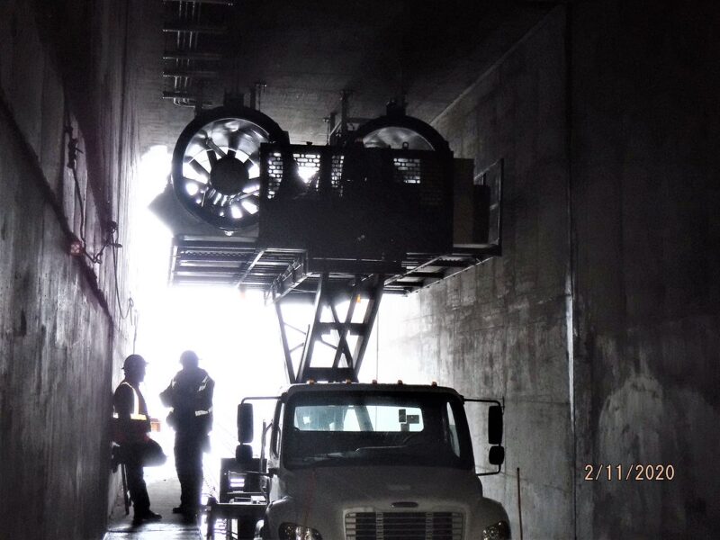 Laying out and installing power and control conduit for the tunnel booster fans in Queens.