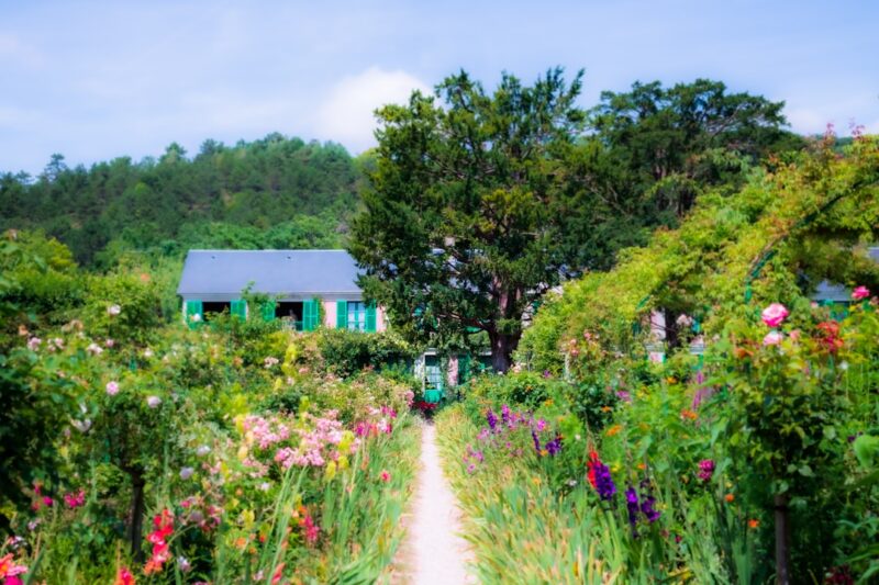 pathway with flowers leading to a cottage in a garden