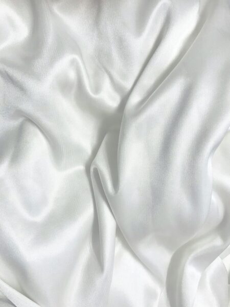 White textile on a brown wooden table suitable for upholstery