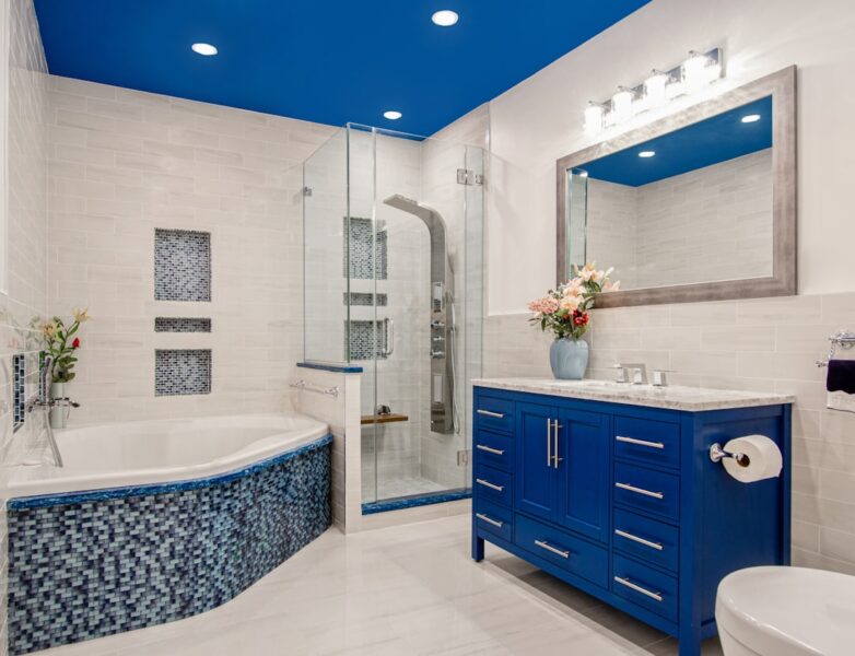 Blue wooden cabinet near white wall in bathroom