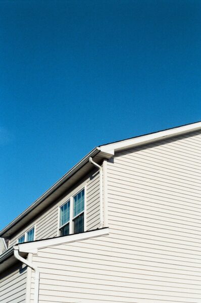 White wooden house with white trim under blue sky