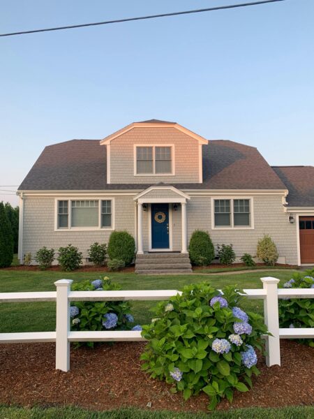 Charming home with hydrangea garden and white fence in Nantucket, MA.