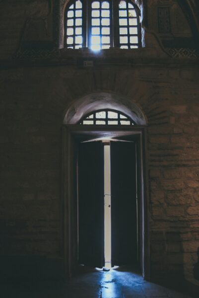 A captivating view of a historic wooden doorway with light streaming in, located in Istanbul.