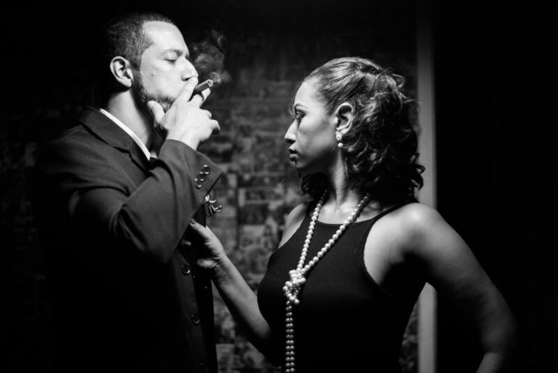 A stylish couple exuding sophistication in a moody black and white portrait