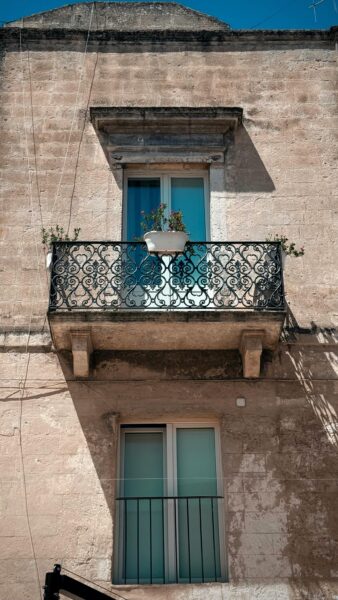 Rustic balcony on sunlit stone building