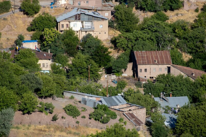 Charming view of traditional village homes nestled among trees in Elazığ, Türkiye.