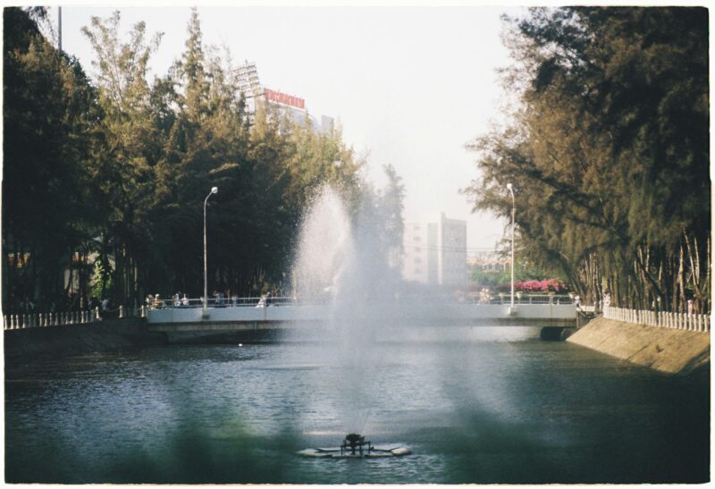 Serene park fountain view with bridge