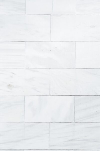 Full frame architecture and home interior textured background of white marble tiled wall pattern.