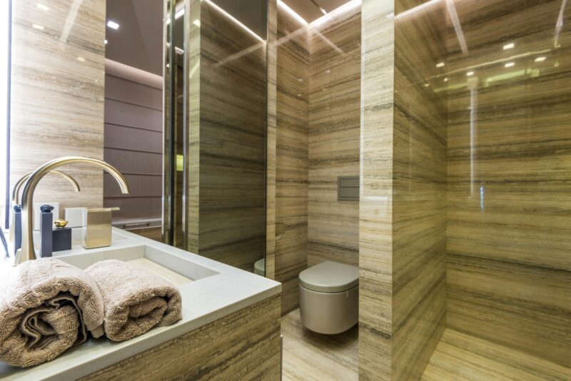 Elegant and luxurious bathroom interior with marble walls and sleek fixtures.