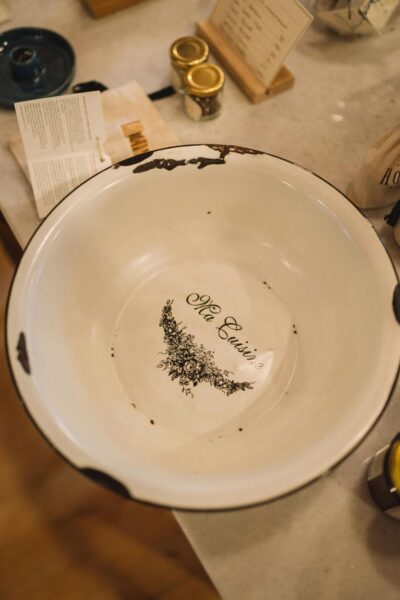 Close-up of a vintage enamel bowl featuring French 'Ma Cuisine' inscription.