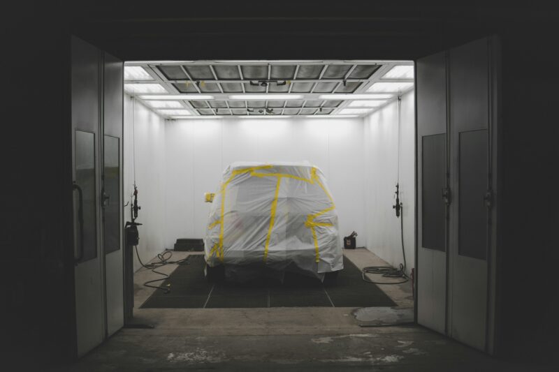 Vehicle covered by white in garage