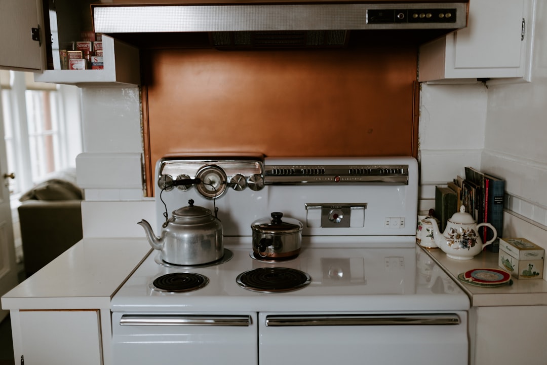Kitchen with shiplap backsplash and electric range