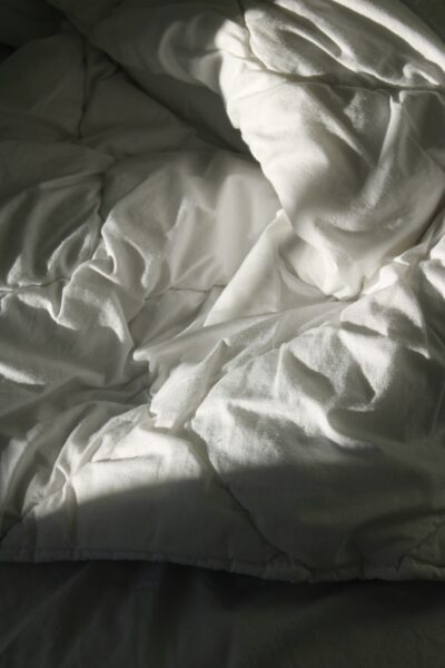 White textile on brown wooden table