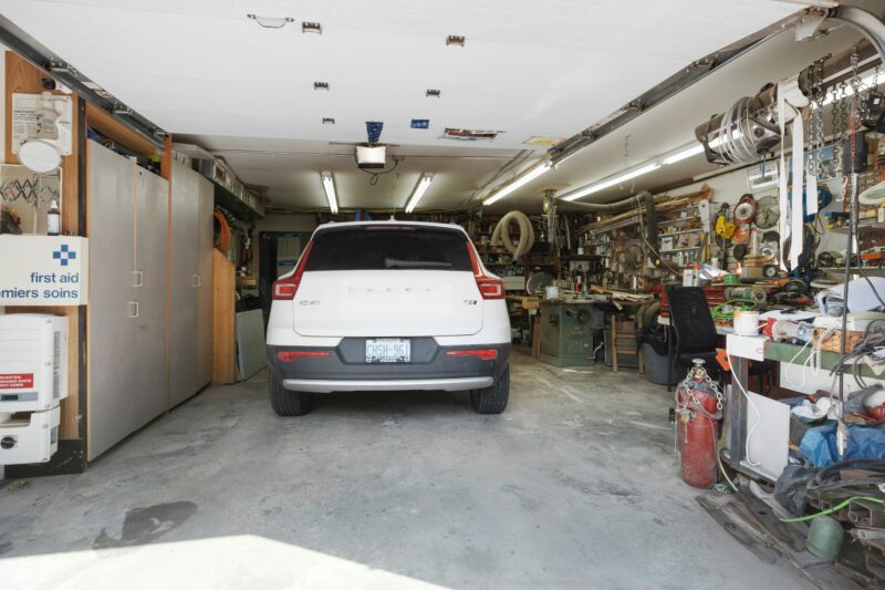 A white car is parked in a garage
