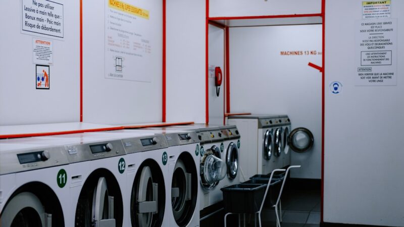 A row of washing machines in a laundry room