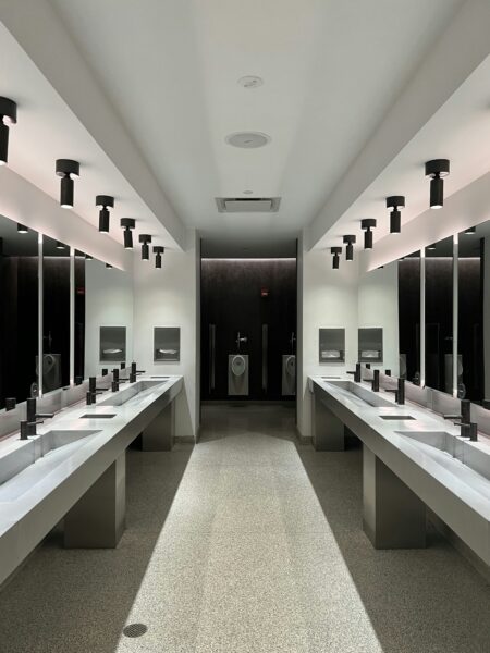 A large bathroom with sinks and mirrors