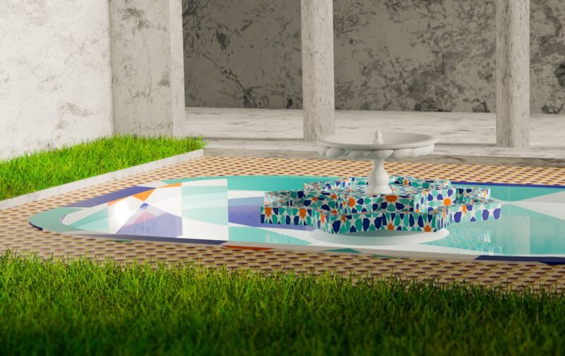a fountain in the middle of a grassy area