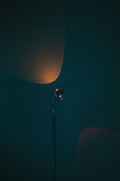 A street lamp in a dark room with a light on