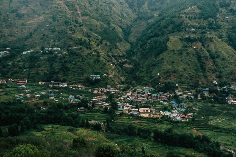 A small village nestled in a valley surrounded by mountains.