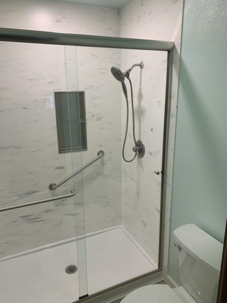 Bathroom with glass shower door and toilet