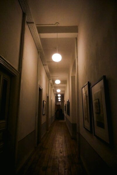 A long hallway with a light hanging from the ceiling