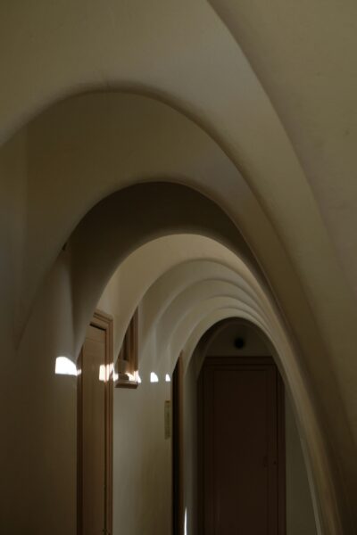 A long hallway with a clock on the wall