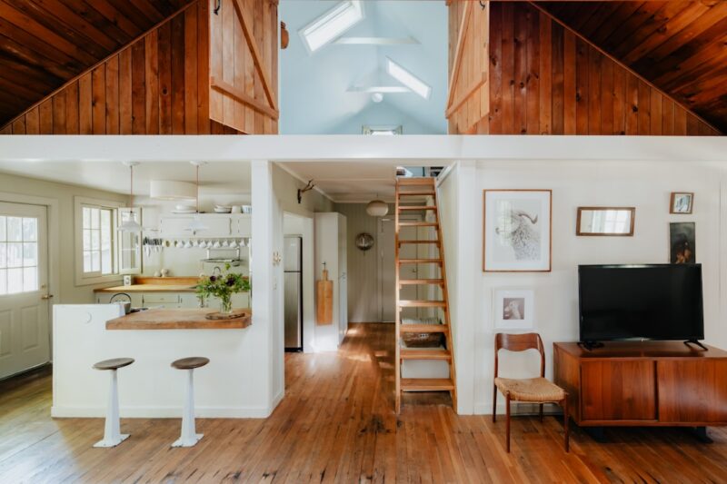 Lake home interior with a split photo of a living room and kitchen