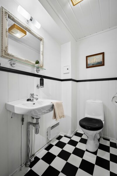 A bathroom with a black and white checkered floor