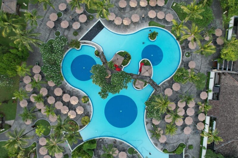 An aerial view of a pool surrounded by trees