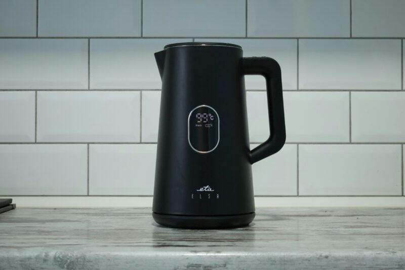 A black coffee pot sitting on top of a counter.