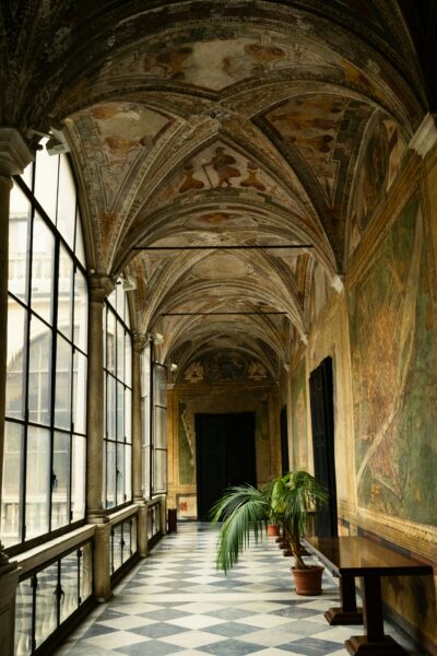 A long, decorated hallway with a tiled floor.