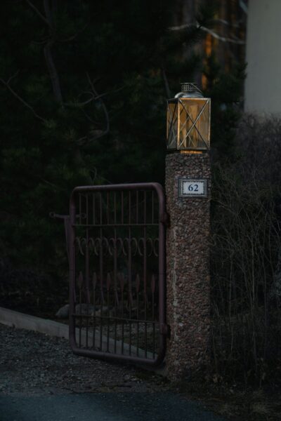 An illuminated gate with an address marker.