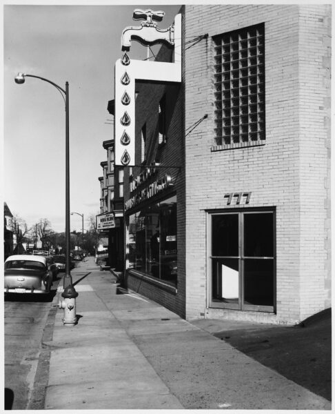 Yellow Brick Building with Glass Block Window Over Corner Door