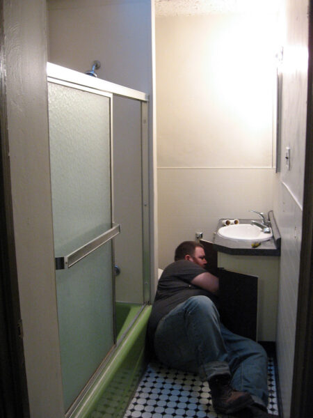 Removing the sink; bathroom with visible pipes and water lines, Philadelphia.