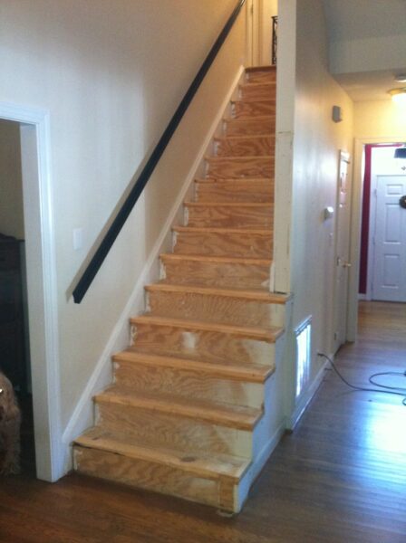 Stairs with removed carpet showcasing bare wood.