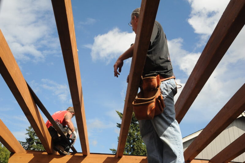 Two men working on deck roof construction, Olympia, Washington.