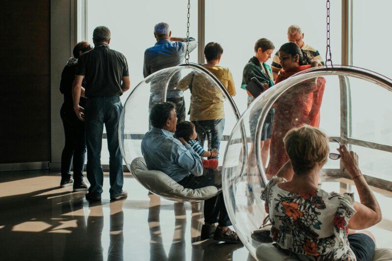 Group of people viewing a city skyline from an observation deck in Dubai, UAE.