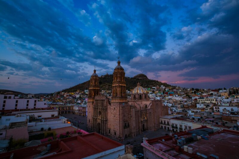 Capture of Zacatecas Cathedral with colorful skyline and cityscape at dusk.