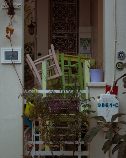 Vibrant wooden chairs and lush potted plants in an Istanbul outdoor courtyard setting.