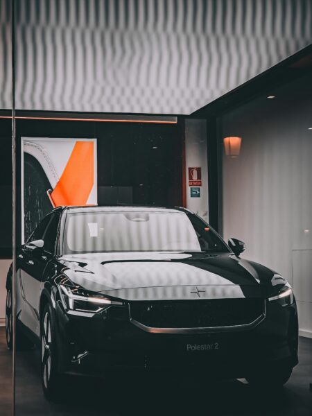 Stylish black electric car showcased in a modern indoor garage in Barcelona, Spain.