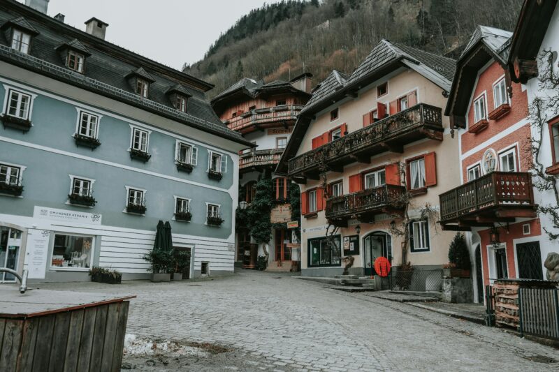 Picturesque European village with colorful rustic buildings and scenic mountain backdrop.