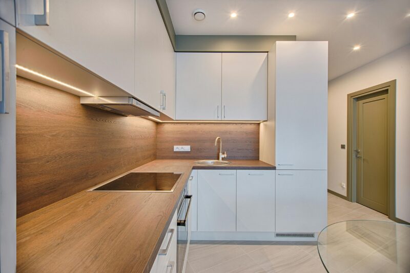 Modern kitchen interior with minimalistic design and wooden accents
